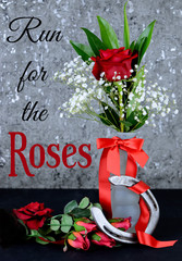 A single red rose in a bud vase on A black table with a red ribbon and a horseshoe for Kentucky...
