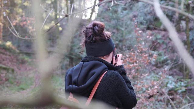 girl taking pictures in the forest