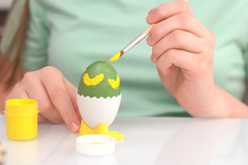 Happy easter. Girl painting Easter eggs. Happy family children preparing for Easter. Cute little child girl wearing bunny ears on Easter day Close up