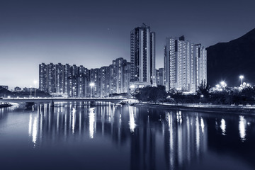 Naklejka premium High rise residential building and mountain in Hong Kong city at dusk