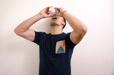 Young man drinking from a jug