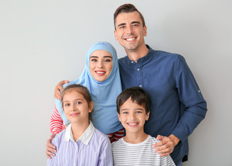 Fototapeta na wymiar Portrait of Muslim family on light background