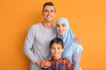 Fototapeta premium Portrait of Muslim family on color background