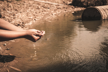 The boy waiting for drinking water to live through this drought, Concept drought and crisis environment.