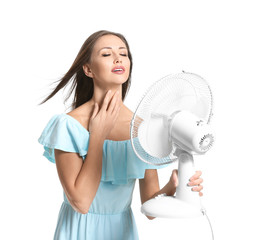 Fototapeta Young woman with electric fan on white background obraz
