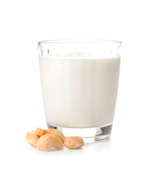 Glass of fresh cashew milk on white background