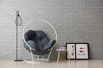 Interior of modern room with comfortable armchair near color wall