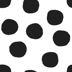 Vector seamless repeat pattern with big bold black irregular hand-drawn polka dots with rough grunge edges on a white background