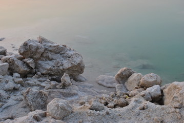 Fototapeta na wymiar Sunrise over the Dead Sea shore in Israel. The lowest place on Earth. Salt crystals at sunrise