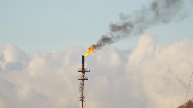 Footage B Roll A Fire on flare stack at refinery oil and gas central processing platform while burning toxic and release over pressure. gas flare at an oil refinery factory industrial. footage b roll.