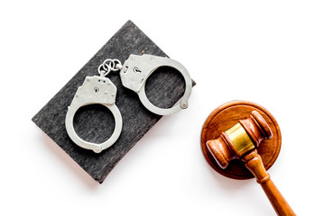 Arrest concept. Handcuffs near judge gavel on white background top-down