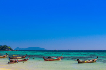 Fototapeta na wymiar A fishing boat floats on Ko Lipe, Thailand on a day with clear blue sea and beautiful sunny skies.