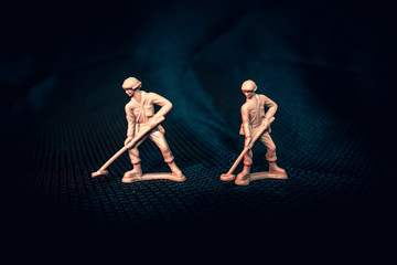 Tan plastic army man with mine sweeper