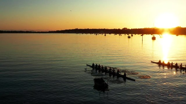 Sunset aerial view at octuple directed by coxswain near Auckland port