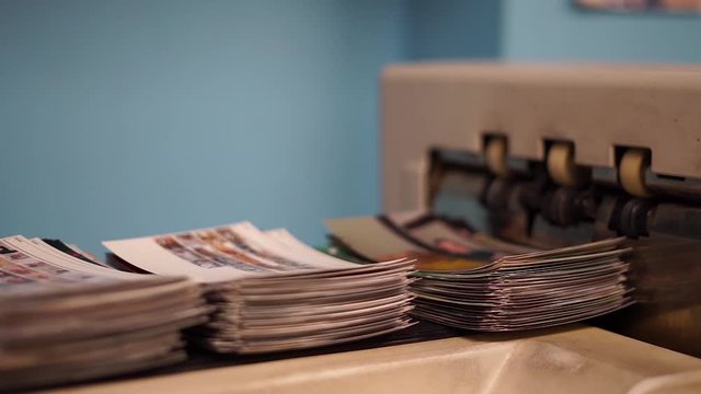 Panning shot of Commercial printer, printing 4x6 at a professional photo store