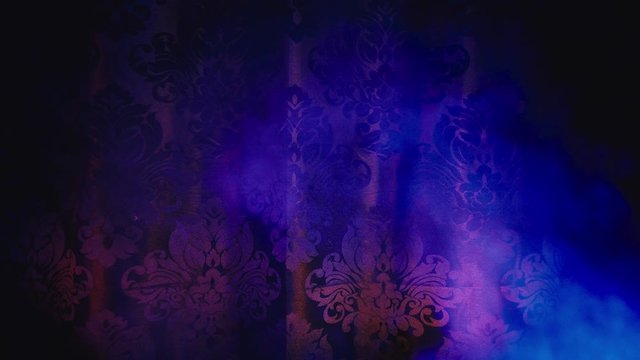 black background with red blue colour lights and smoke