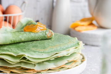 Green pancakes with matcha tea and mango jam