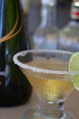 Close up of a margarita with salted rim and lime