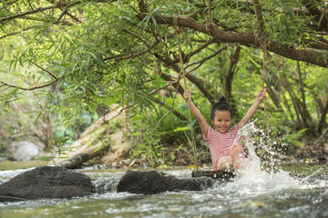 Fototapeta na wymiar happy little asian girl and child having fun to playing in the river in summer time with smile and laughing healthy, smiling face adorable. Summer camp for kids. vacation lifestyle concept.