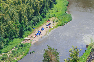 campground near the river near the forest, aerial view