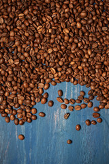 Pile of coffee beans on blue wood