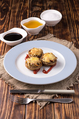 baked mushrooms with cheese serving on a plate.