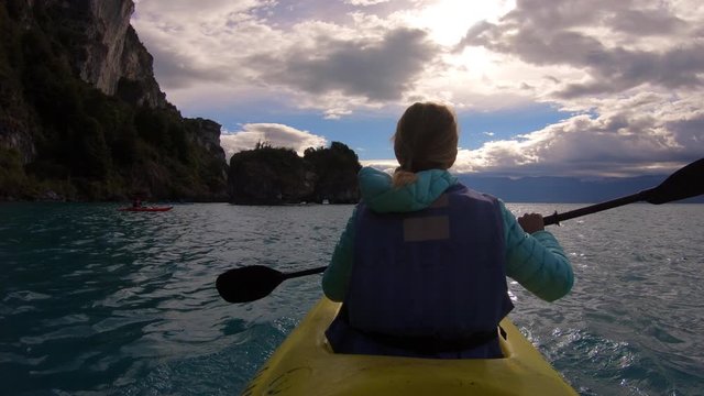 Woman explores limestone rock formation and swims inside the cave (Marble Caves) on the lake General Carrera in Chilean Patagonia, Aysen region, Chile