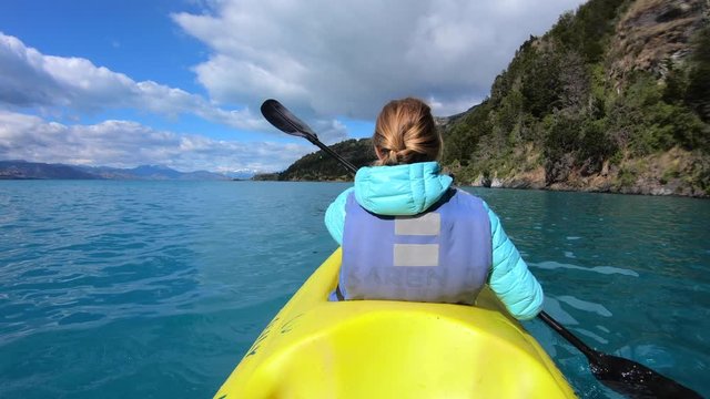 Woman explores limestone rock formation and swims inside the cave (Marble Caves) on the lake General Carrera in Chilean Patagonia, Aysen region, Chile