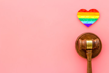 LGBT divorce. Rainbow heart near judge gavel on pink background top-down copy space