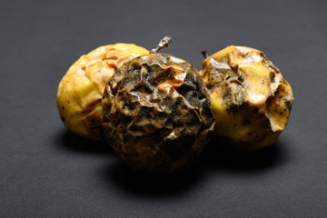 over ripe passion fruits on a dark background