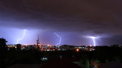 3 Lightning strike over Kempton park in johannesburg in an urban area, Blue and white Lightning bolt strike over showing absolute energy that is in nature that is so unpredictable and beautiful