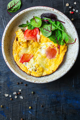 omelette scrambled vegetables and salad, healthy snack (corn, tomato, onion and other ingredients) menu concept background. top view. copy space