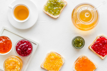 Tea party with jam. Toast, teapot, cup on white background frame copy space