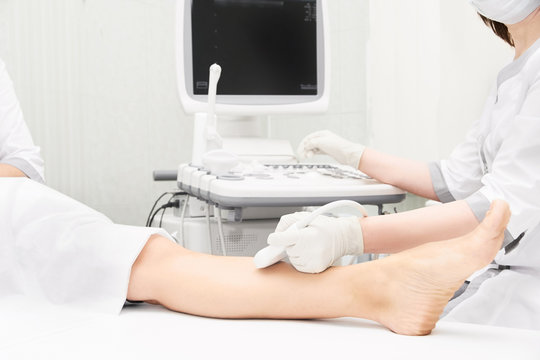 Doctor ultrasound knee test. Scan medical equipment. Diagnosis ultrasound foot