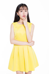 Beautiful young girl in yellow skirt, white background.
