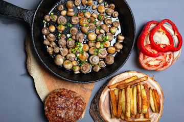 fried junk food top view. homemade high-calorie cuisine:   mushrooms, potato,cutlet with vegetables flat lay