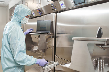 Scientists in protective suits in a medical laboratory conduct medical research in search of a vaccine