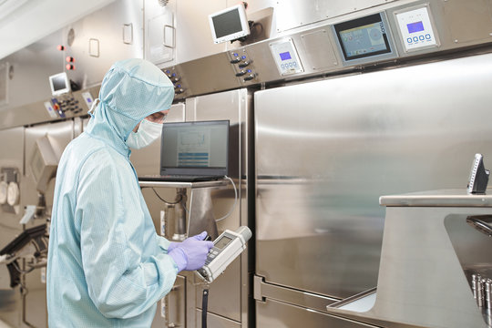 Scientists in protective suits in a medical laboratory conduct medical research in search of a vaccine