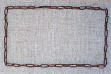 old iron chain lies on burlap