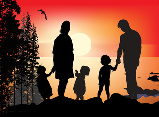 family silhouettes near sea at sunset