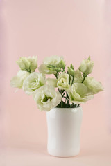 bunch of white eustoma flowers in glass vase
