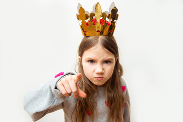 Evil child girl with a crown on a white background