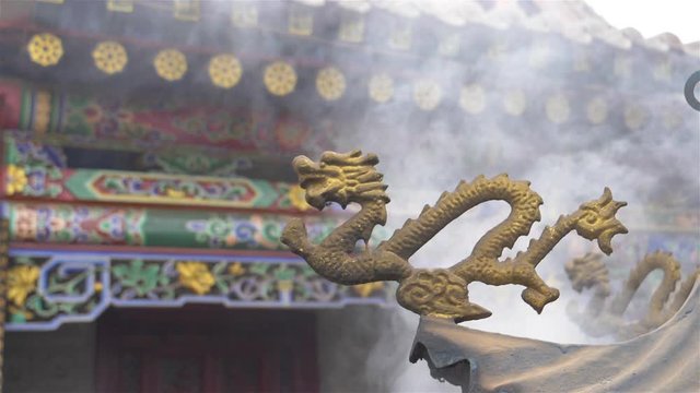 Foggy incense smoke in the air and dragon sculpture in Temple of NanShan Mountain, Xining Qinghai China.
