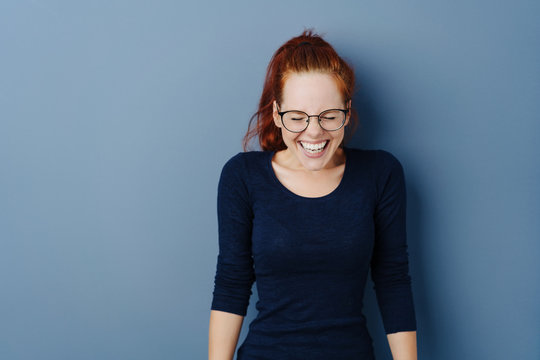 Cute young woman giggling to herself