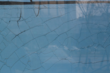 cracked blue wall and glass background