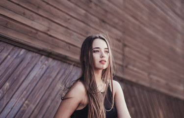 Fototapeta premium fashionable portrait of a beautiful woman with long hair in an urban setting