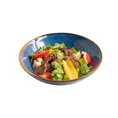 Salad with slices of cheese, slices of pork, sweet pepper and fried in a pan, isolated on white. photo for the menu