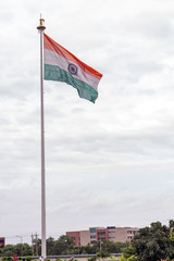 Beautiful Low angle shot of Indian flag with residential apartments and sky in the background. Independence day concept