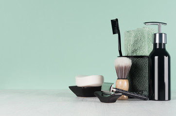 Fashion men toiletry accessories in black color in green mint menthe and white interior - razor, toothbrush, towel, soap, dispenser.
