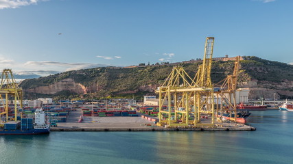 Naklejka premium Aerial view of the sea cargo port and container terminal of Barcelona timelapse, Barcelona, Catalonia, Spain.